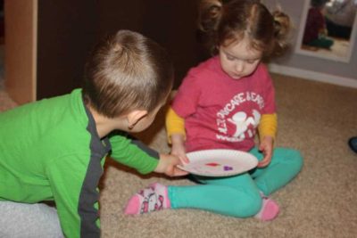 two preschoolers playing table manners game