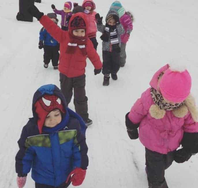 family child care group walking in winter gear