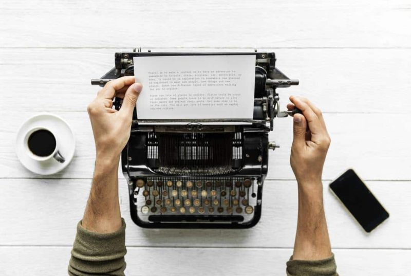 hands typing at a typewriter writing up child care contract for a daycare program