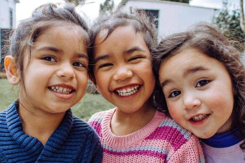 three young girls smiling