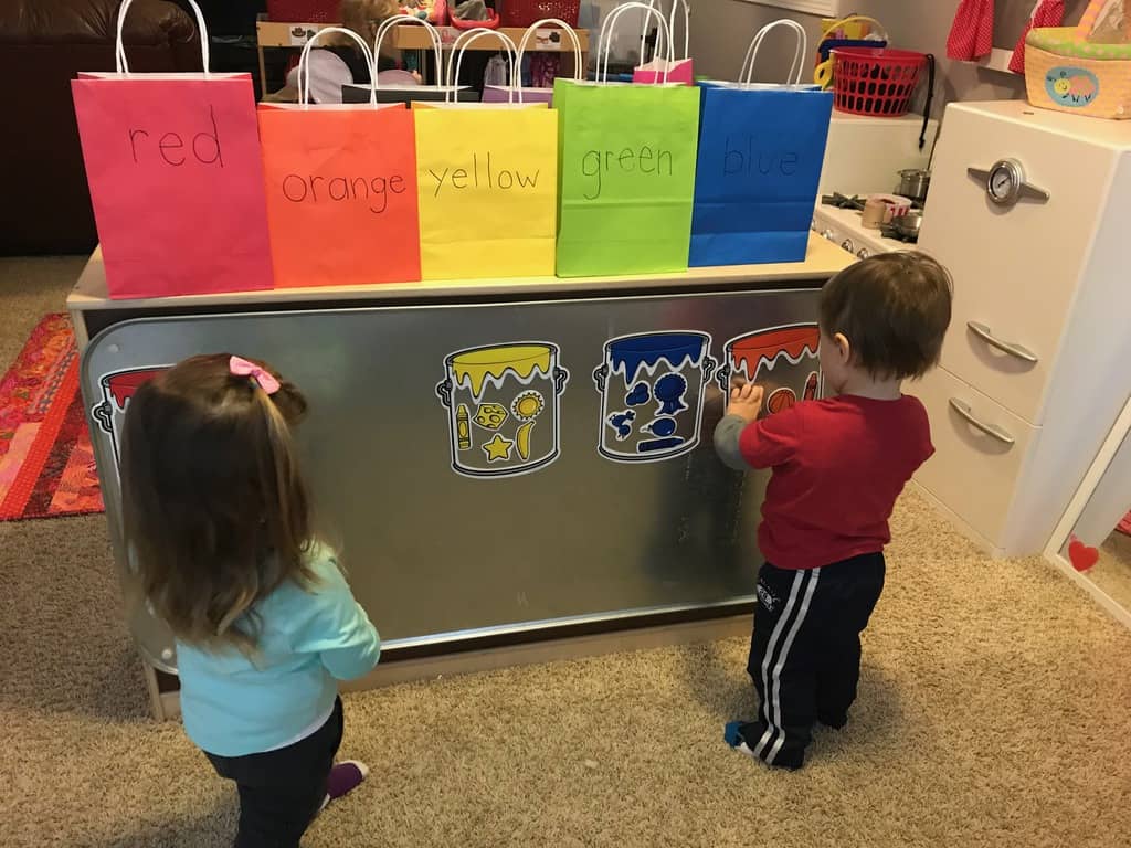 young boy and girl playing with colors