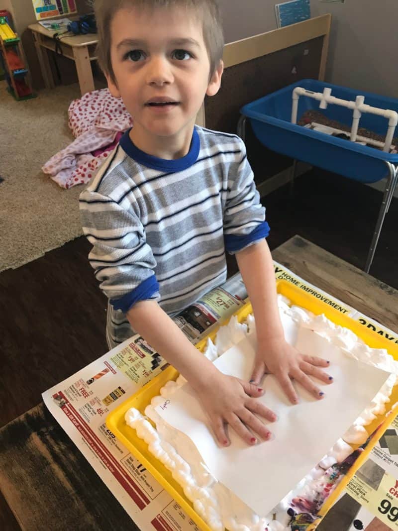 boy painting with shaving cream