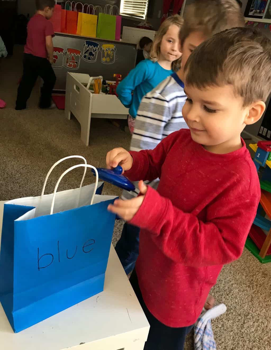 young boy with blue gift bag