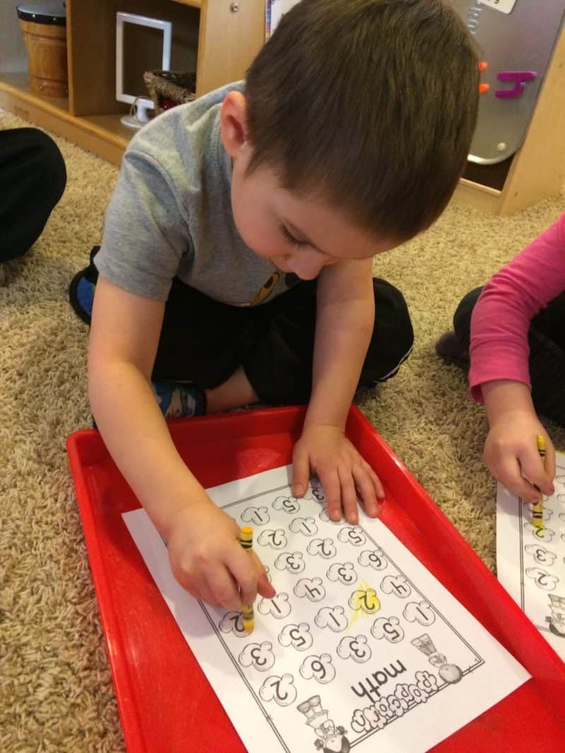 young boy coloring popcorn worksheet