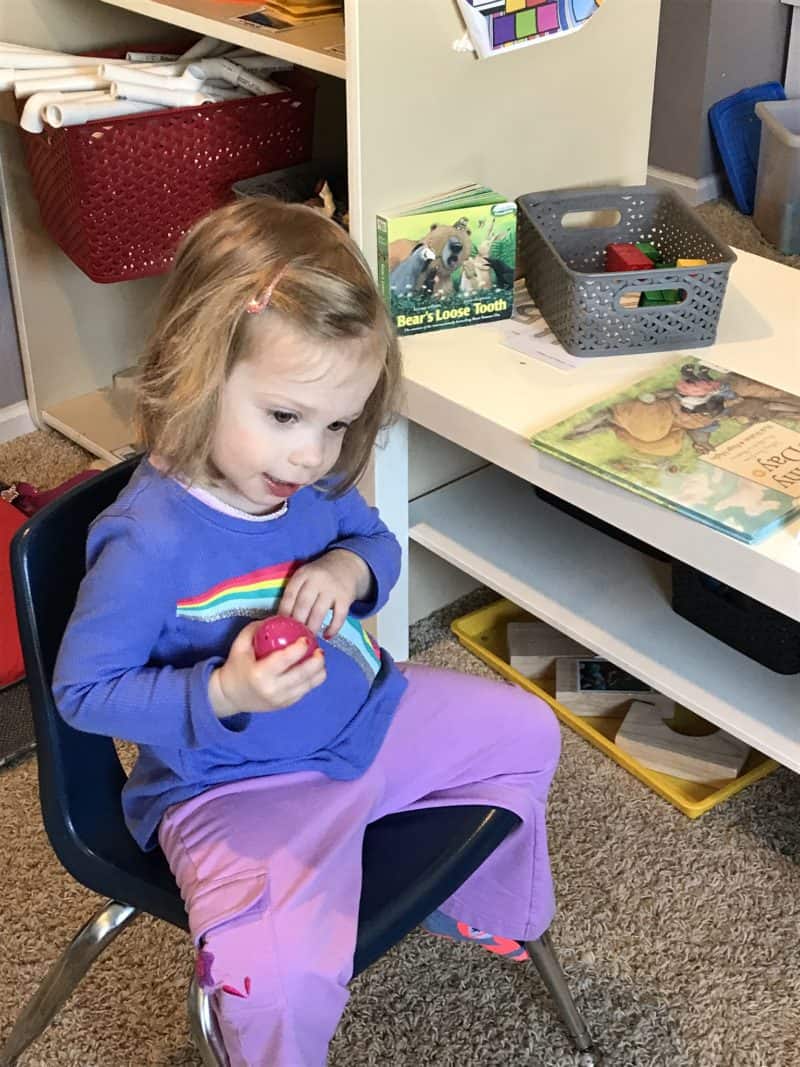 young girl holding plastic egg