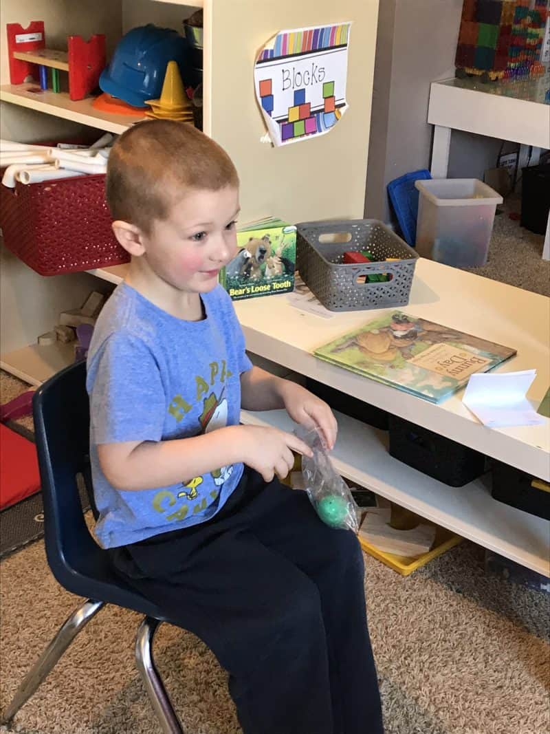 young boy holding a toy egg 