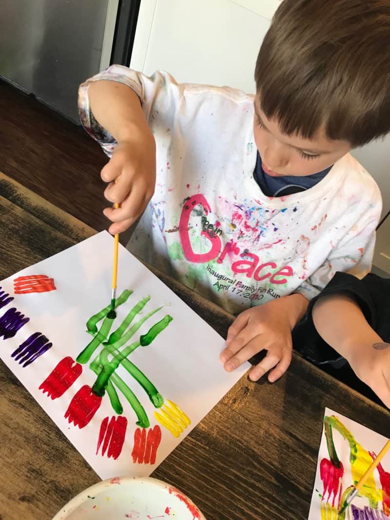 boy painting tulips