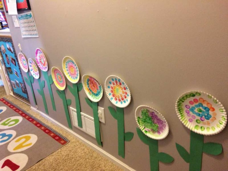 row of paper flowers on the wall