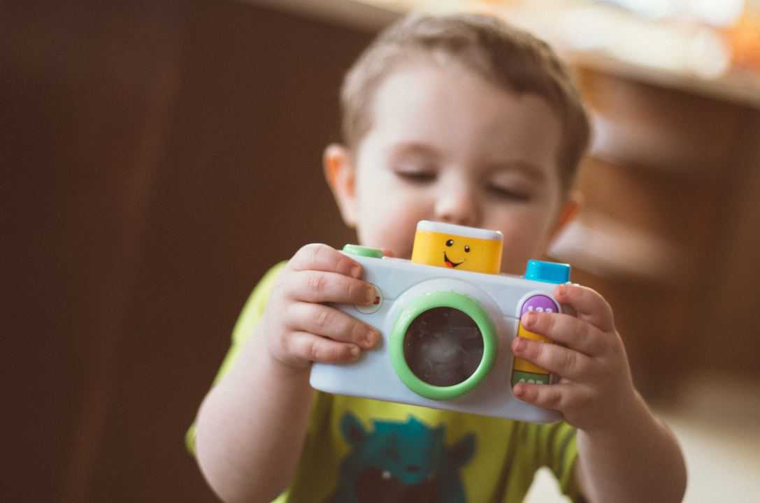 toddler sharing toy camera