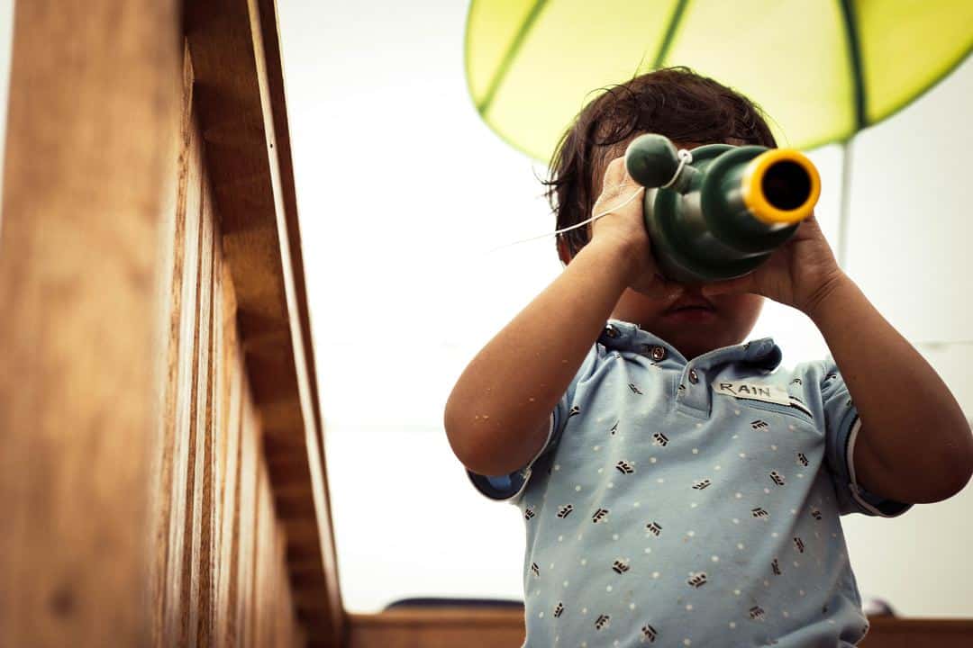 Young boy looking through telescope