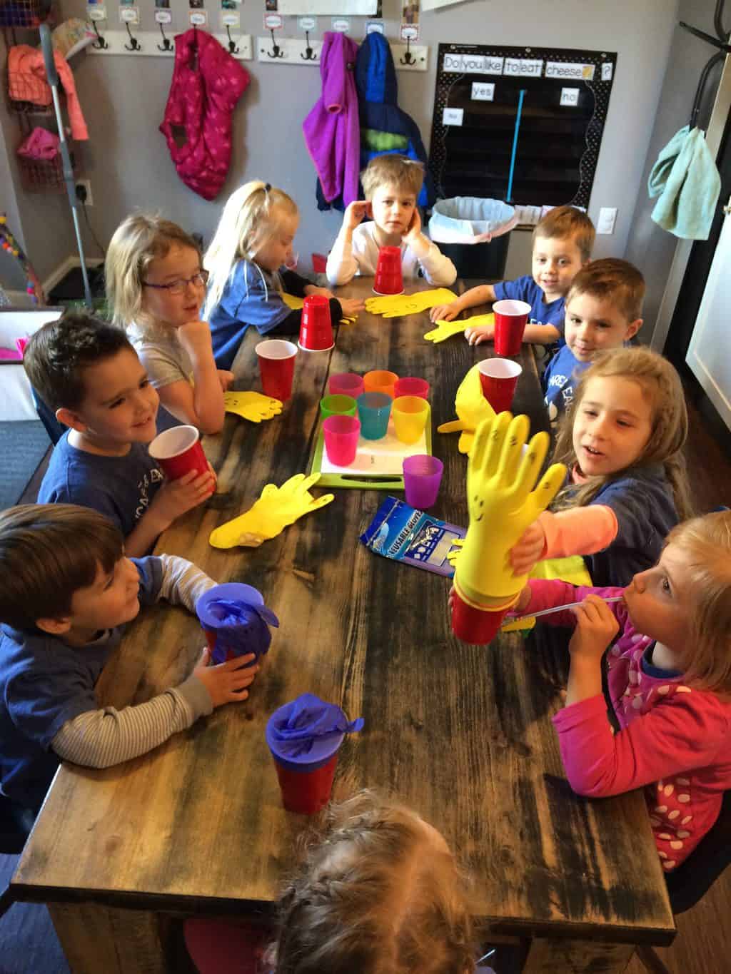 science activities for preschoolers with group of young kids making glove and cup project