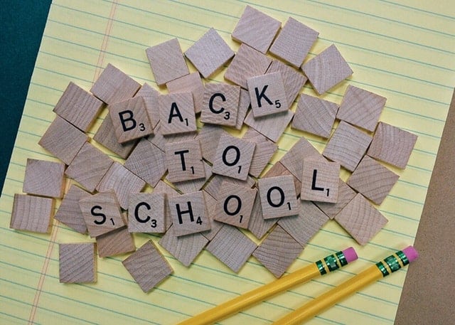 scrabble tiles in a pile that spell out back to school