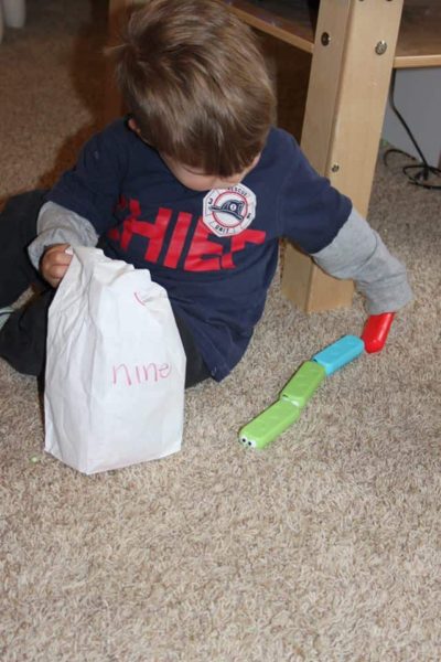 hands on math activities for preschoolers with a young boy counting blocks