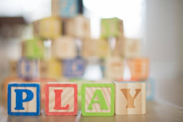 wooden toy blocks that spell out the word play