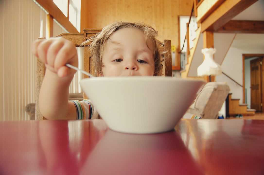 boy eating out of a bowl with meal from lunch menu ideas