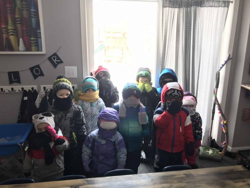 group of family child care kids dressed for winter